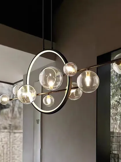 A linear take on the globe chandelier, perfect for long spaces. The combination of the LED ring and glass spheres provides both ambient and focused light.
