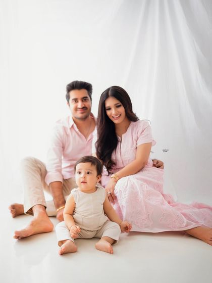 A lovely family portrait with everyone seated together, creating a feeling of warmth and togetherness.