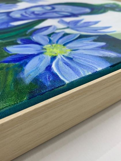A detail shot showing the texture of the canvas within the floater frame. This style allows the entire painted surface, including the sides, to be visible.