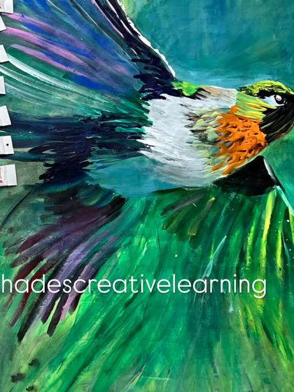 A work-in-progress shot of a hummingbird, highlighting the layering process with acrylic paints to build rich, feathered textures.