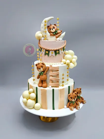A stunning three-tier teddy bear themed baby shower cake in neutral shades, perfect for a sophisticated celebration.