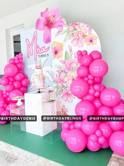 A vibrant and tropical-chic theme for a 9th birthday, featuring bold pink balloons and a backdrop with hibiscus flower illustrations.