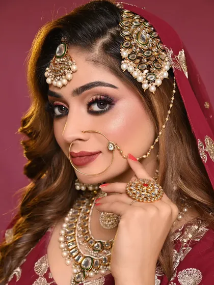 A stunning close-up of a traditional Indian bridal look created by one of my students. Notice the precision in the winged eyeliner, the soft blend of the eyeshadow, and the radiant skin finish, all key elements of our professional portfolio shoots.