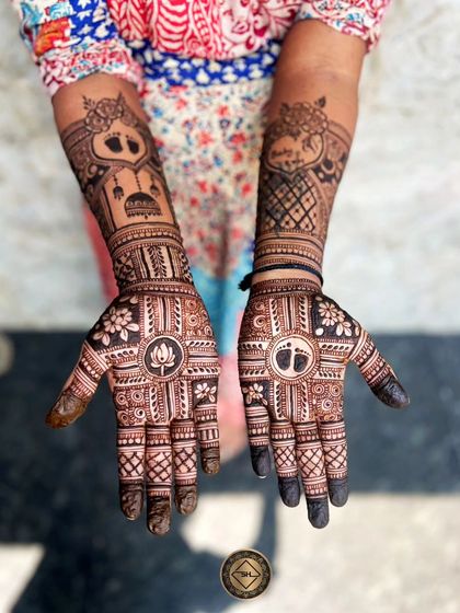 This custom baby shower design features a traditional cradle on one forearm and a lotus on the palm. The other hand has a baby footprint in the center of the palm, making it a very personal and meaningful design for the mom to be.