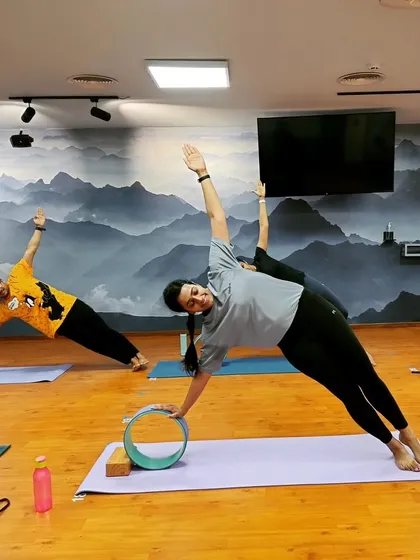 Building core and shoulder stability with a Vasisthasana (Side Plank) variation using the yoga wheel. This adds a challenge of balance and control to the pose.