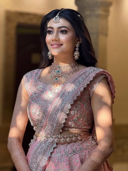 A beautiful shot of the bride in her pink reception lehenga, the soft light creating a radiant glow around her.