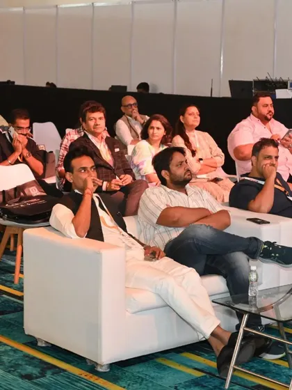 The front row of a panel discussion, featuring industry leaders and experts fully engaged in the topic.
