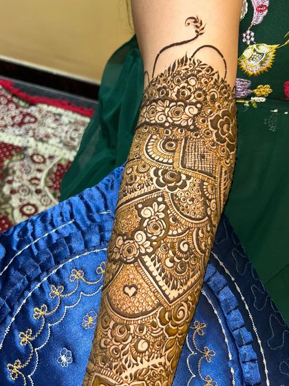 Another close-up of the intricate patterns on the arm. This design includes a small heart, a sweet personal touch.