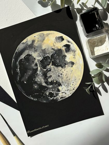 A flat-lay shot of my gouache moon painting on black paper. I love how the white and yellow highlights pop against the dark background, creating a dramatic and realistic lunar portrait.