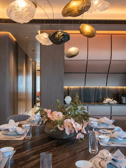 In this dining space, sophistication and functionality blend seamlessly. The centerpiece, a bespoke dining table with a unique veined marble top, is paired with elegant chairs from Giorgetti and Baxter, creating a perfect balance of comfort and aesthetics.