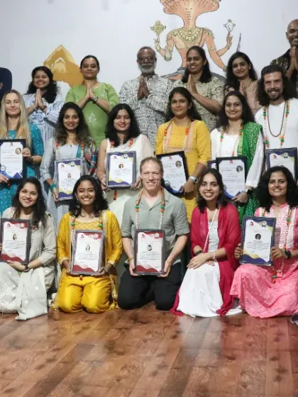 A large and vibrant group of students celebrating the completion of their 300-hour Yoga TTC. The mix of joy and accomplishment in this photo is what makes our residential programs so special.