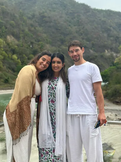 Sharing a happy moment with new friends against the backdrop of the Rishikesh mountains. The bonds formed during a retreat are truly special.