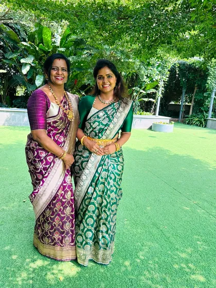 A gorgeous mother-daughter duo. While their Banarasi sarees are different, I designed their blouses to create a subtle coordination, proving that family outfits do not always have to be identical to be perfectly in sync.