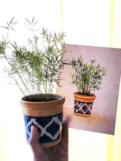 A real plant held next to its watercolor counterpart. Our classes often involve observational drawing and painting to help you capture the world around you.