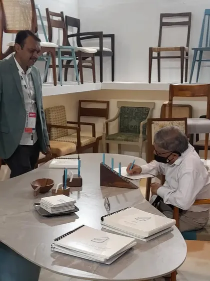 A visitor taking down notes while exploring the chairs on display. I was happy to see so much interest in the details of my work.