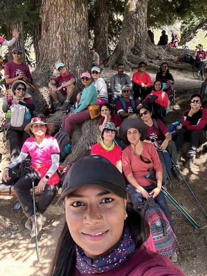 A happy group selfie taken while resting under the shade of ancient trees on the trail. It is all about the journey and the people you share it with.
