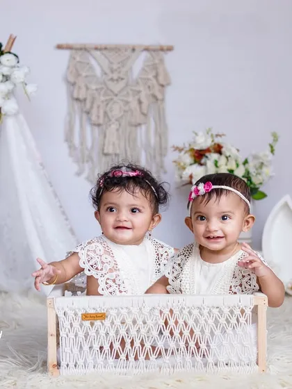 Double the smiles and double the fun. I specialize in capturing the unique connection between twins, like in this adorable boho-themed shoot with a macrame backdrop and soft, natural textures.