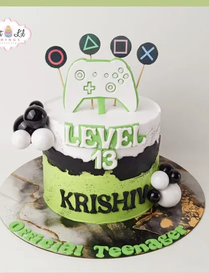 Level 13 unlocked! A cool PlayStation-themed cake for an official teenager, featuring a game controller and the iconic button symbols.