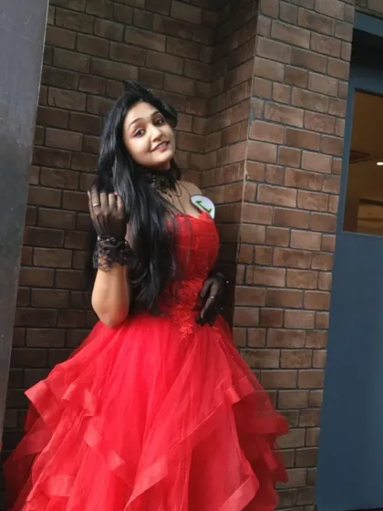 A full-length view of a client enjoying her moment in our red ball gown. The voluminous skirt creates a beautiful silhouette.