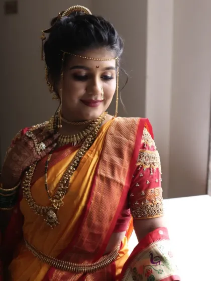 A serene portrait of the bride by the window, the soft light enhancing her glowing makeup.