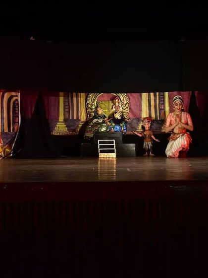The full stage view during a court scene, with a live dancer paying respect to the puppet king and queen. This demonstrates the scale of our productions.