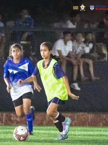Nizh Kapadia in a practice match, wearing a bib and focused on the play. These internal games are crucial for tactical development and building team chemistry.