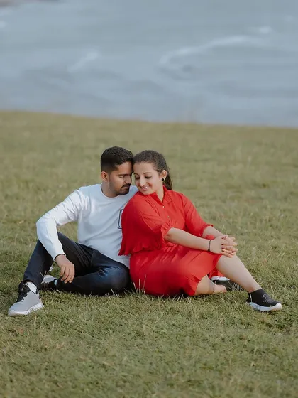 A tender moment sitting together on the grass, with the sea in the background. This combines the beauty of both hills and coast.