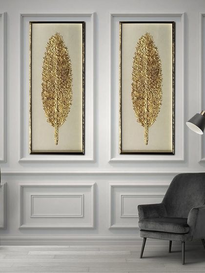 This pair of shadow boxes features tall, elegant golden feathers. The intricate, textured detail of the feathers creates a luxurious and timeless look, perfect for a sophisticated living space.