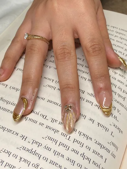 It's okay to be obsessed with these ultra-shiny, 3D gold-wrapped nails. This design is pure luxury.