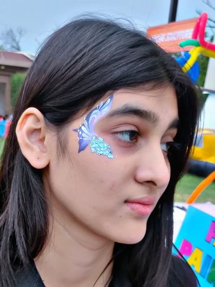 A beautiful abstract butterfly design in purple and blue, with a touch of silver glitter.