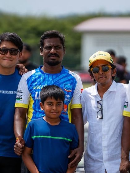 A proud team photo with one of our young drivers. We are a family, and we support each other through every high and low.