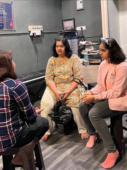 A mother and daughter attend a vocal session together. We welcome families to learn and grow musically in our supportive environment.