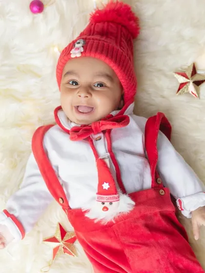 A joyful shot from above, with Christmas lights and stars creating a beautiful holiday mood. This little Santa's smile is infectious!