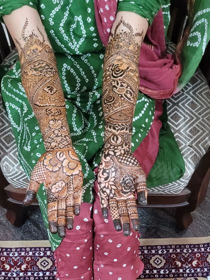 This bridal design has a wonderful mix of bold floral work on the palms and more delicate, intricate patterns moving up the arms.