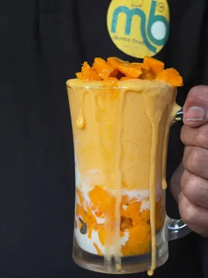 The wait is over! My Mango Feast is here. This picture shows my delicious mango shake, a perfect treat for the summer season.