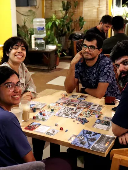 This group is enjoying a game of 'Brew', a strategic and beautifully illustrated board game from our collection.