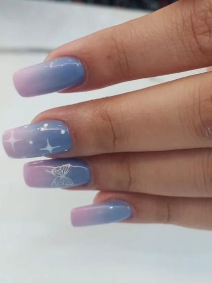 A dreamy pastel ombré with hand-painted stars and a butterfly.