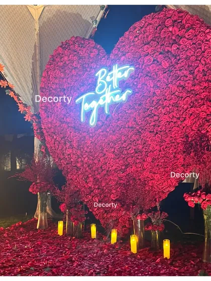 A massive heart-shaped backdrop made entirely of red roses, with a 'Better Together' neon sign. This makes for a stunning photo opportunity and a romantic focal point for any proposal or anniversary.