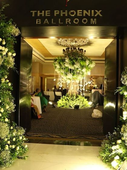 A grand entrance to the "Phoenix Ballroom," where we installed our magnificent Wish Tree. The towering floral arrangements at the doorway set the tone for the elegant, nature-inspired reception inside.