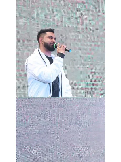 Music is the universal language. Here I am on the mic, connecting with the crowd and letting the music do the talking.