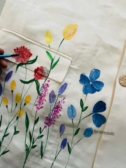 Painting a minimalist garden on a suit coat. I used delicate brushstrokes and a variety of colors to create the feeling of a wildflower meadow.
