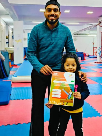 This little gymnast is happy to receive her "JUMP" program certificate.