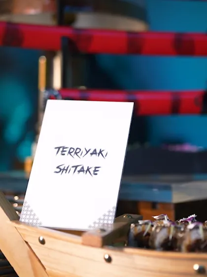 A sign for Terriyaki Shiitake, hinting at the rich and savoury Japanese flavours available at our live stations.