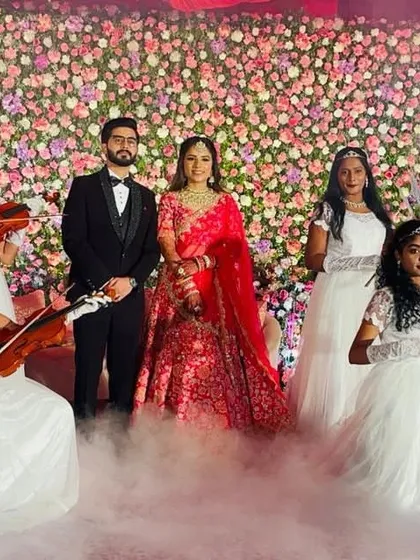 Make your wedding entrance truly magical. We create storybook moments, like this beautiful angel entry where performers with violins welcome the couple, surrounded by ethereal smoke for a dreamy, romantic atmosphere.