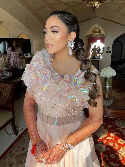 The bride looking radiant with her unique and playful hairstyle.