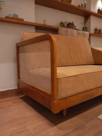 My custom sofa set in a client's home. The blend of rattan sides, luxurious fabric upholstery, and a robust teak wood frame creates a refined and enduring centerpiece.