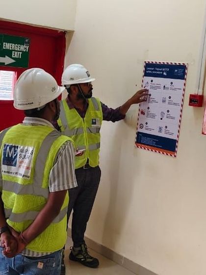 A safety officer reviews the LOTO procedure chart with technicians before starting maintenance work. This step-by-step verification is crucial to ensuring all safety protocols are followed correctly.