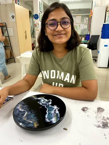 A participant with her finished marble-effect resin clock. This workshop teaches you how to create elegant and sophisticated designs.