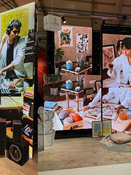 The 'Goblin Mode' installation uses split screens to create a dynamic backdrop for the physical space. The still photographs of characters indulging in informal activities reinforce the narrative of rejecting productivity culture for comfort and self-care.