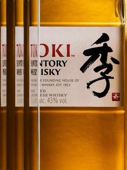 Using reflections to create a pattern. By placing mirrors, I multiplied the Toki bottle, creating a repeating graphic of the label. This is a purely photographic effect that adds visual complexity to a simple product.